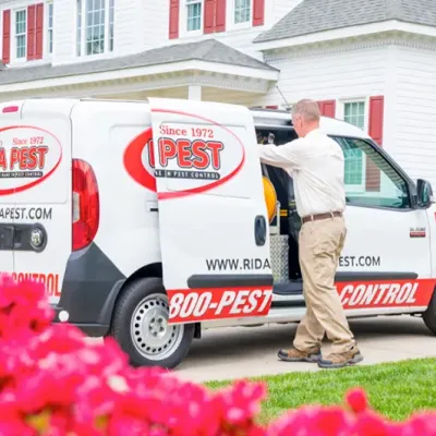 pest service technician next to van