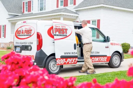 pest service technician next to van